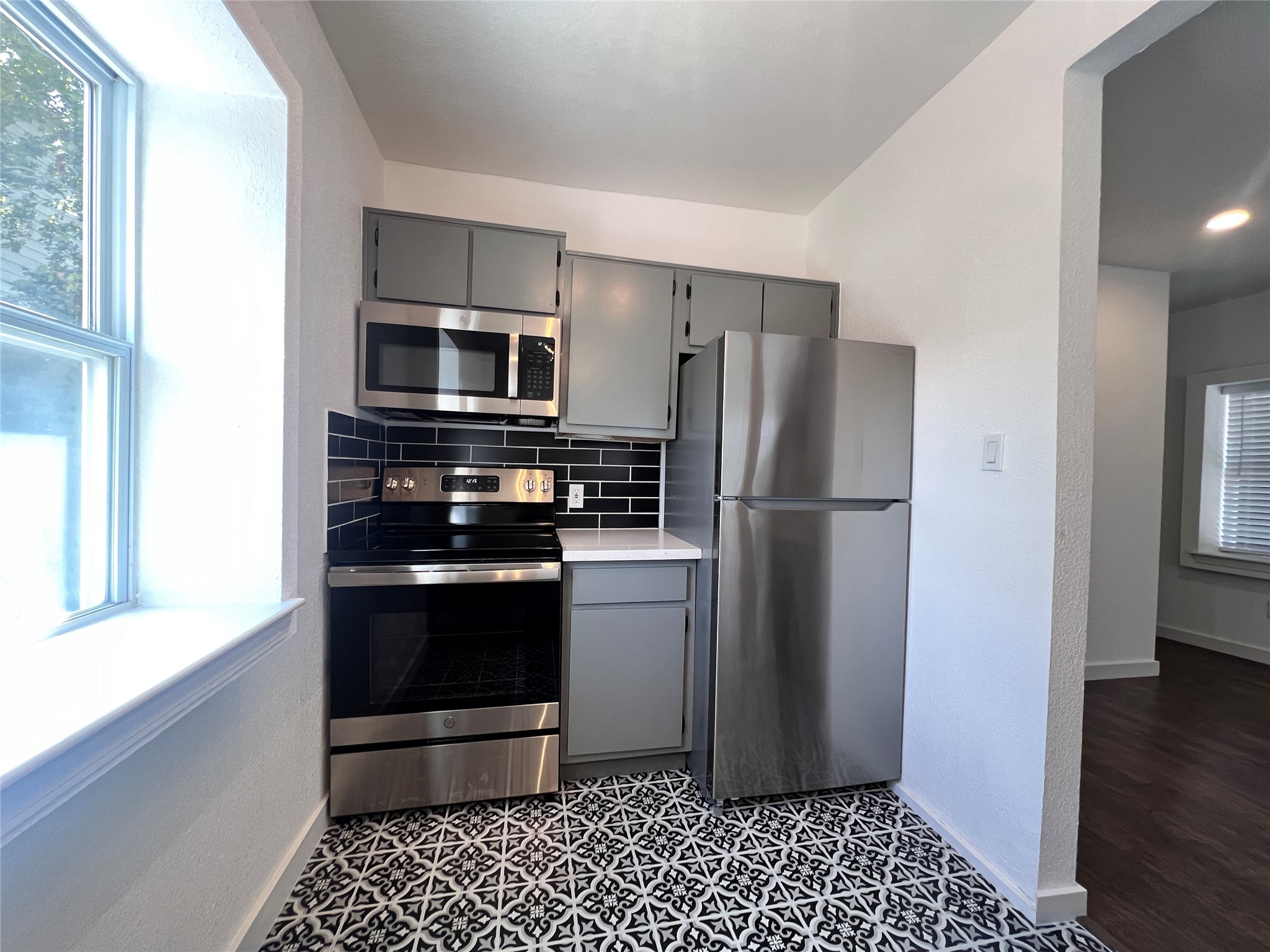 415 Fairview Street, Unit 6 Houston, TX 77006 - Photo 6 of 11 a kitchen with a refrigerator stove and cabinets