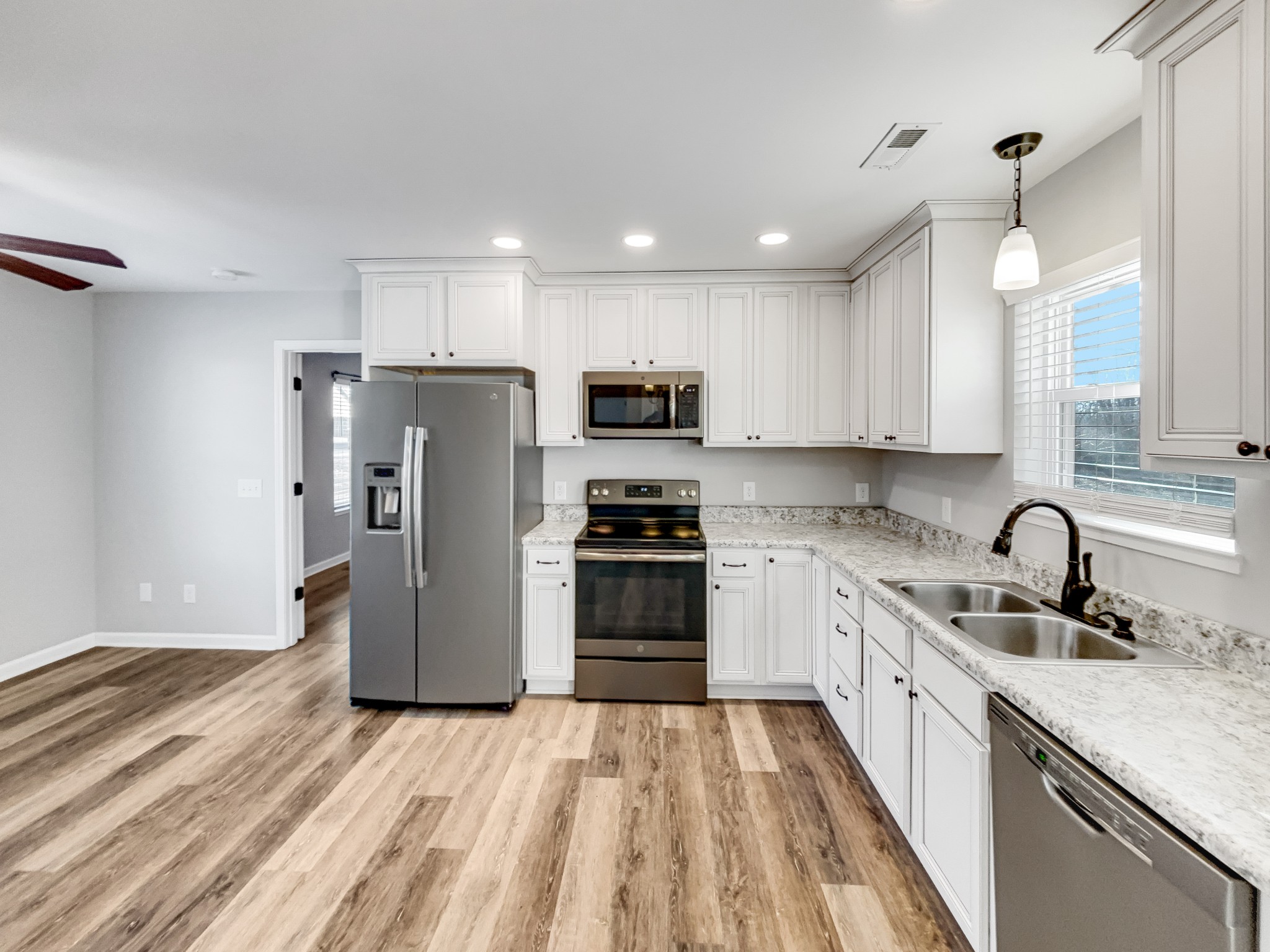 7689 South Swift Road Goodlettsville, TN 37072 - Photo 6 of 18 a kitchen with a sink a counter space stainless steel appliances and cabinets