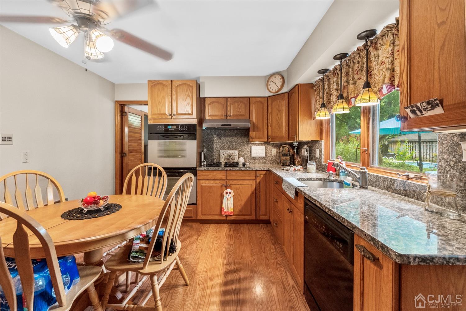 417 Ridge Road Dayton, NJ 08810 - Photo 13 of 37 a kitchen with stainless steel appliances granite countertop a sink a stove and chairs