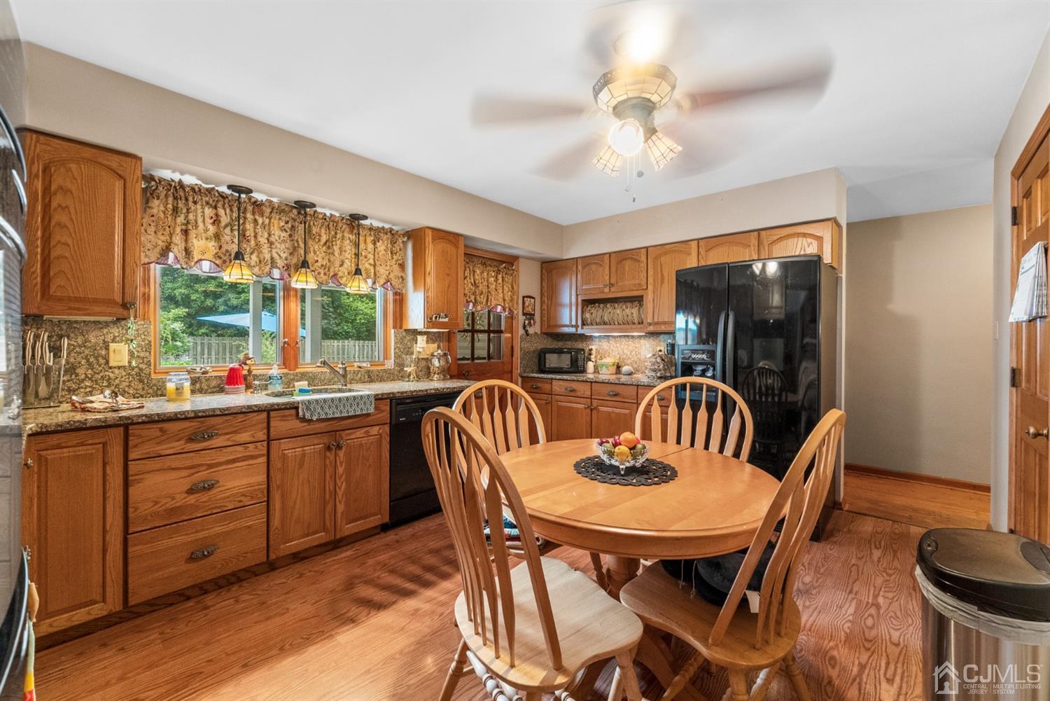 417 Ridge Road Dayton, NJ 08810 - Photo 14 of 37 a dining room with furniture a window and a chandelier