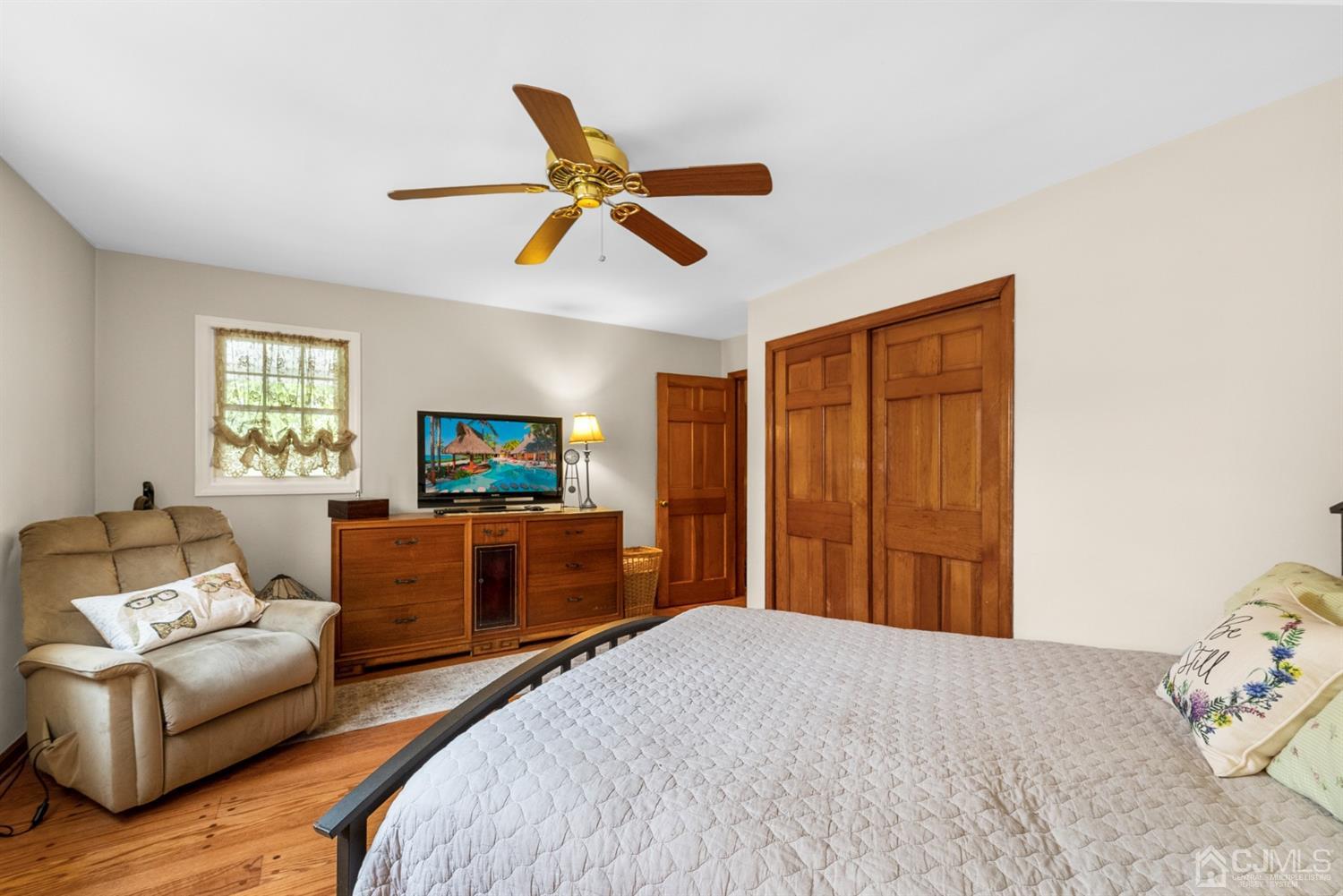 417 Ridge Road Dayton, NJ 08810 - Photo 22 of 37 a bedroom with a bed and wooden floor