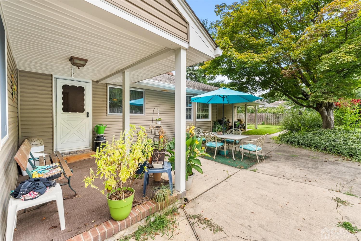417 Ridge Road Dayton, NJ 08810 - Photo 36 of 37 a view of a patio with table and chairs under an umbrella