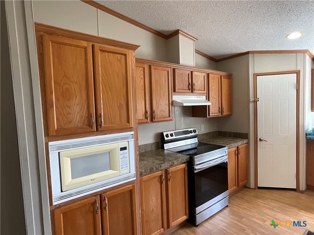 383 County Road 233 Hallettsville, TX 77964 - Photo 9 of 48 a kitchen with stainless steel appliances granite countertop a stove a sink and a refrigerator
