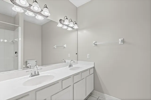 a bathroom with a sink vanity and a mirror