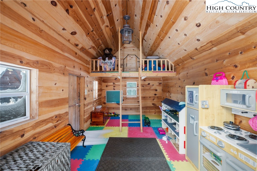 123 St Andrews Road Beech Mountain, NC 28604 - Photo 45 of 50 a room with lots of white furniture and wooden floor