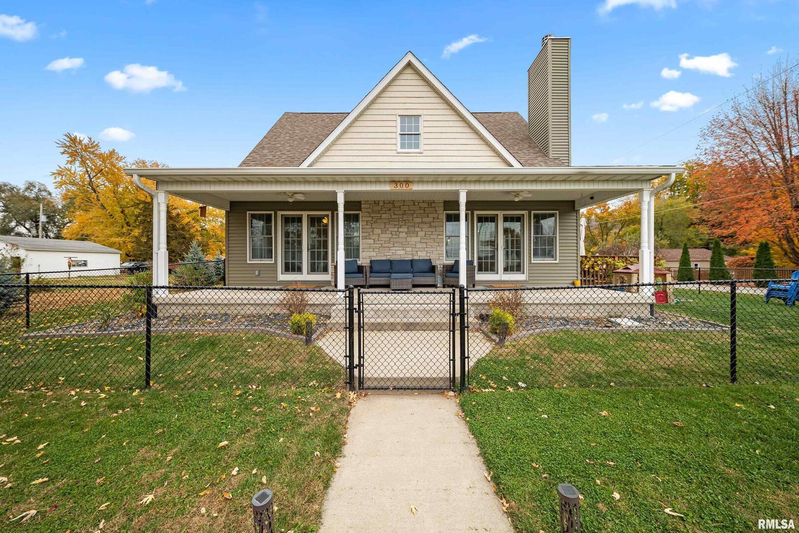 a view of a house with backyard and sitting area