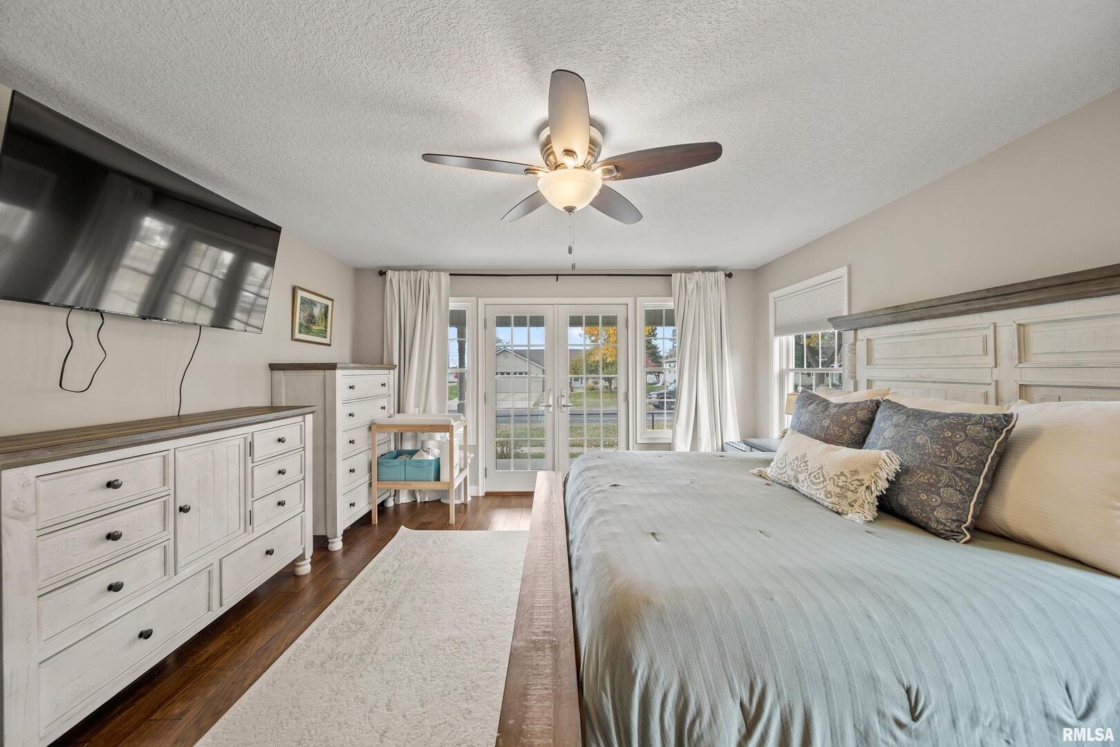 300 2nd Avenue Hampton, IL 61256 - Photo 11 of 32 a bedroom with a large bed and a chandelier