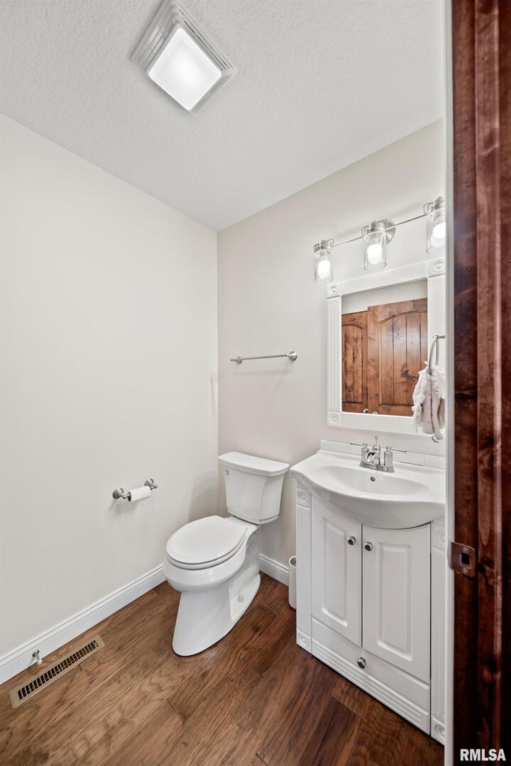 300 2nd Avenue Hampton, IL 61256 - Photo 15 of 32 a bathroom with a toilet a sink and a mirror