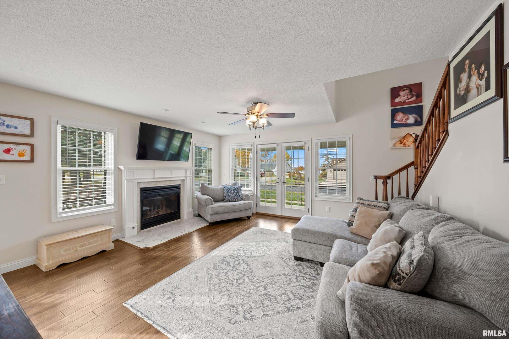 300 2nd Avenue Hampton, IL 61256 - Photo 17 of 32 a living room with furniture and a fireplace