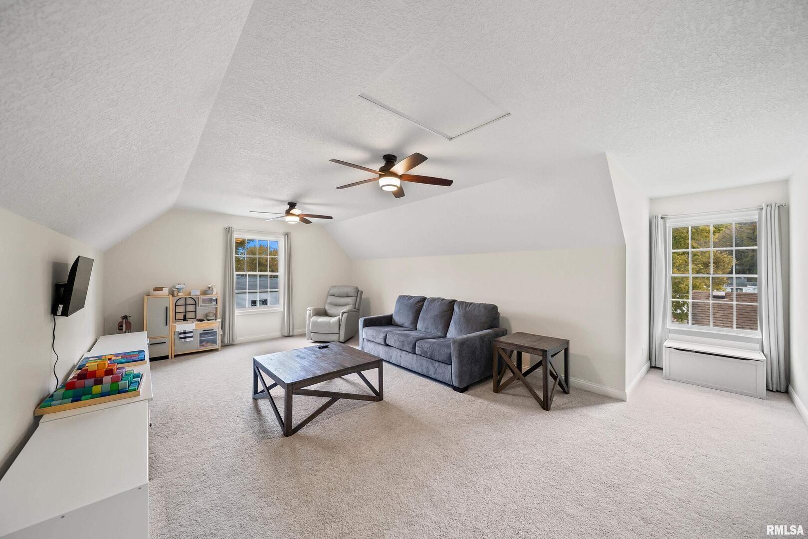 300 2nd Avenue Hampton, IL 61256 - Photo 23 of 32 a living room with furniture and a flat screen tv