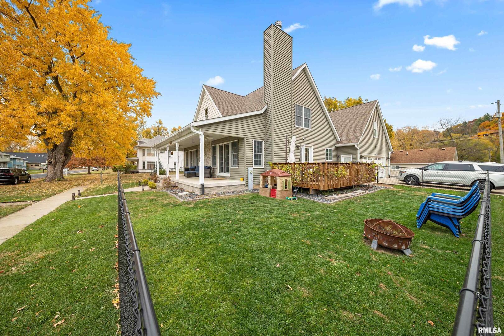 300 2nd Avenue Hampton, IL 61256 - Photo 30 of 32 a view of a house with a backyard porch and sitting area