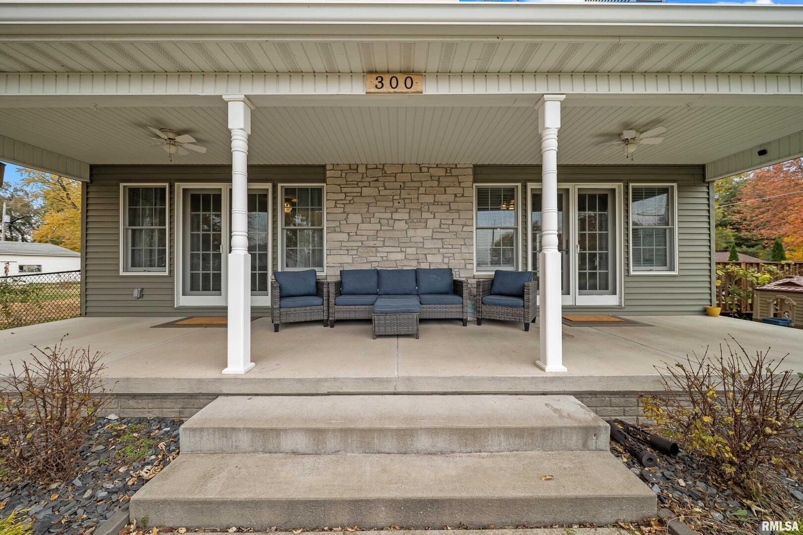 300 2nd Avenue Hampton, IL 61256 - Photo 3 of 32 a house with potted plants in front of door