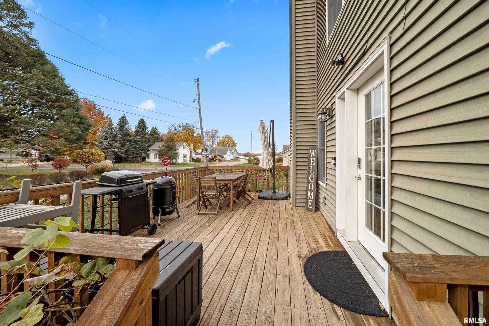 300 2nd Avenue Hampton, IL 61256 - Photo 32 of 32 a view of a balcony with wooden floor and outdoor seating