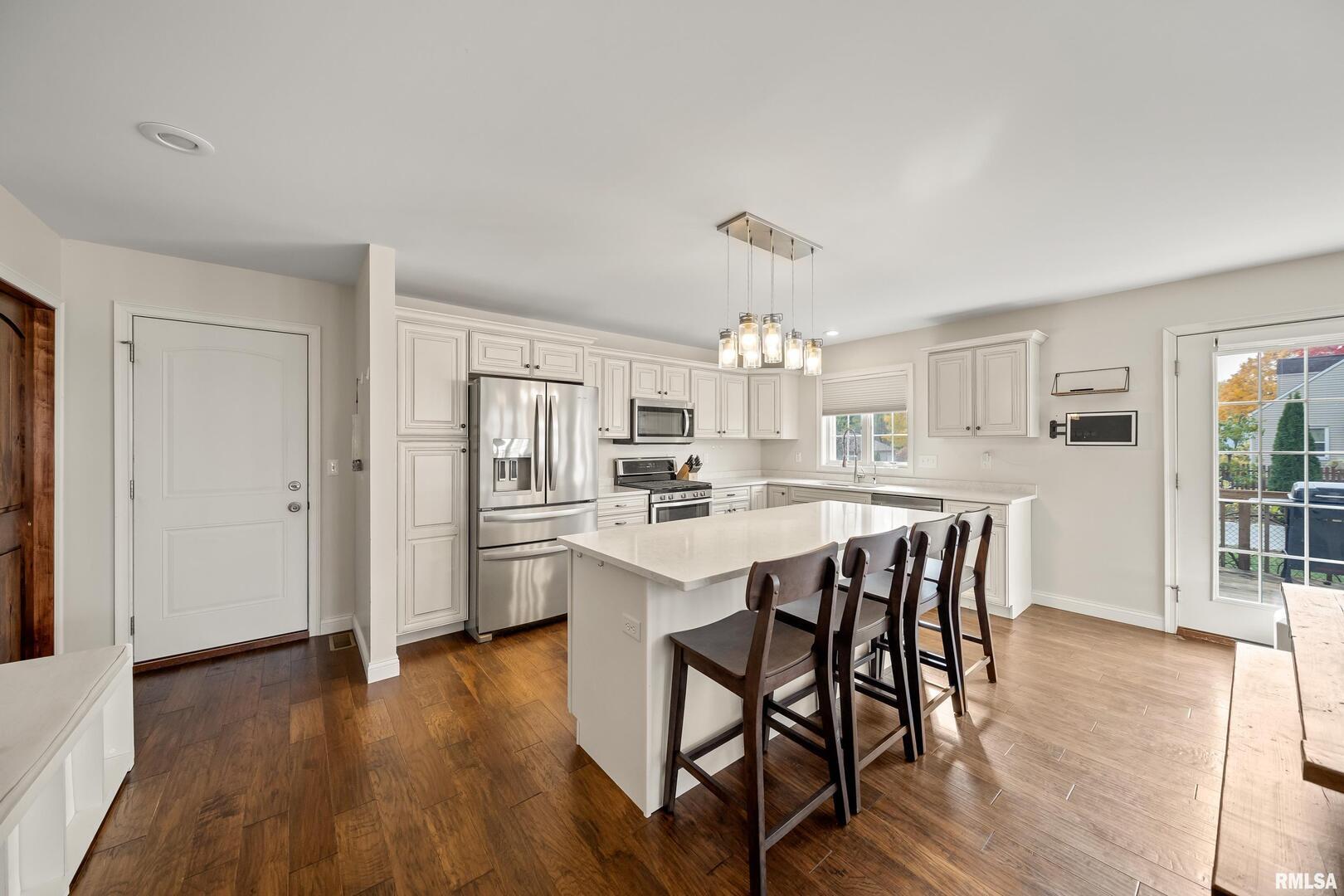 300 2nd Avenue Hampton, IL 61256 - Photo 6 of 32 a kitchen with stainless steel appliances a dining table chairs and sink