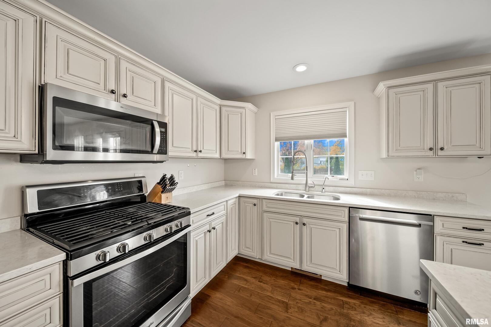 300 2nd Avenue Hampton, IL 61256 - Photo 7 of 32 a kitchen with granite countertop cabinets stainless steel appliances and a sink