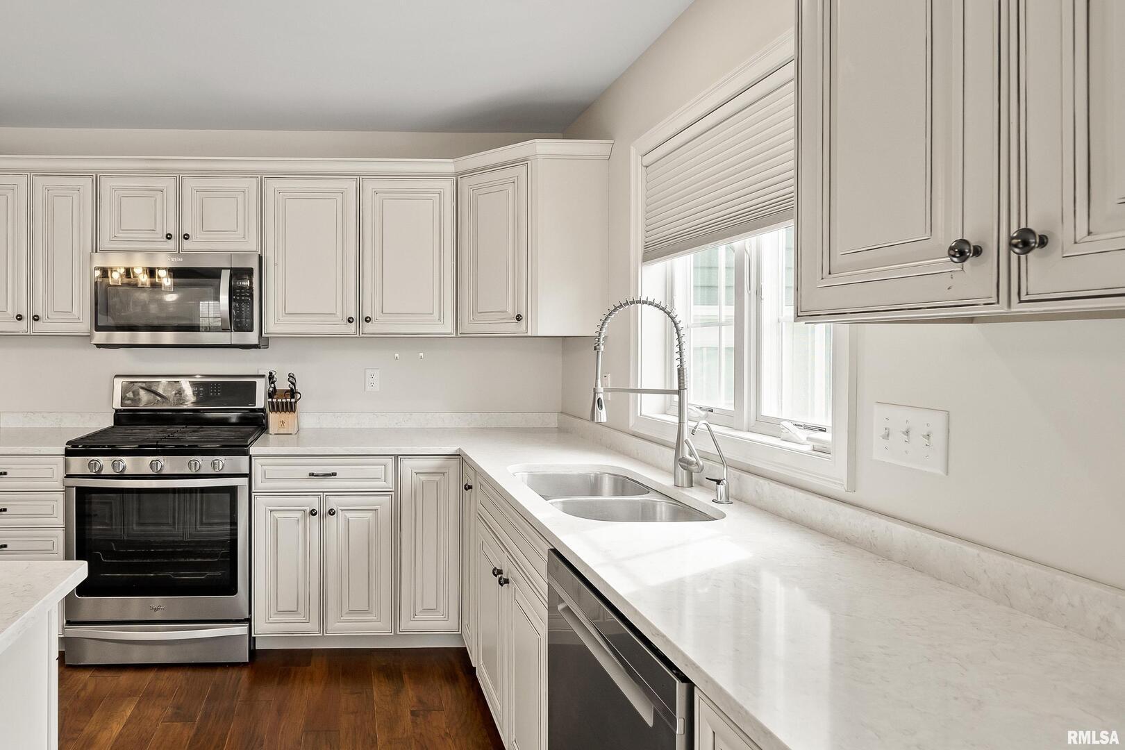 300 2nd Avenue Hampton, IL 61256 - Photo 8 of 32 a kitchen with granite countertop a sink cabinets and stainless steel appliances