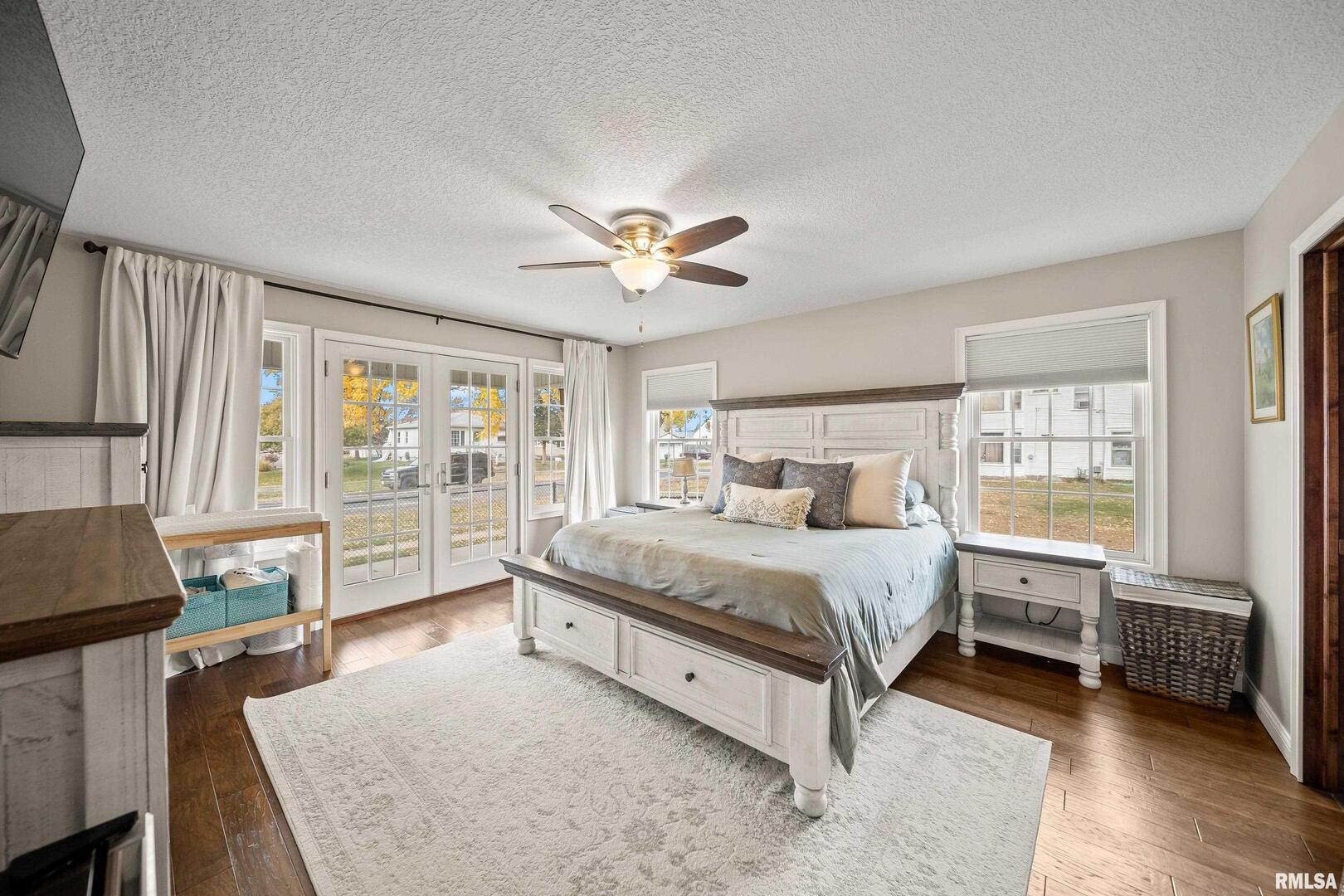 300 2nd Avenue Hampton, IL 61256 - Photo 10 of 32 a spacious bedroom with a bed a dresser and a large window