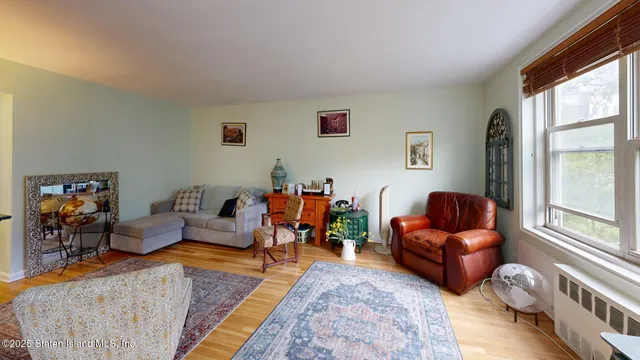a living room with furniture kitchen view and a window