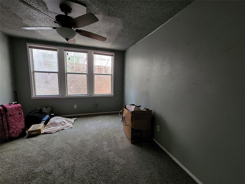 511 West Sycamore Street, Unit A Denton, TX 76201 - Photo 7 of 10 Miscellaneous room with ceiling fan, carpet, and a textured ceiling