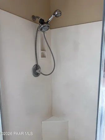 a bathroom with a shower and a mirror