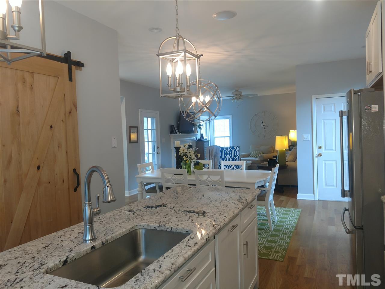 12101 Amoretto Way Raleigh, NC 27613 - Photo 6 of 15 a kitchen with a sink and chandelier