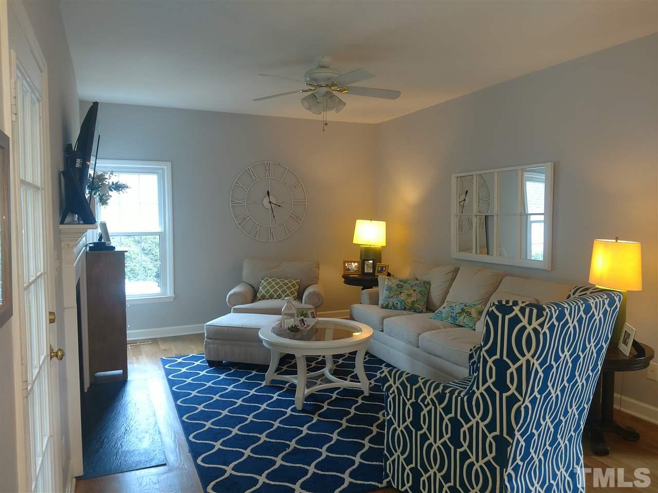 12101 Amoretto Way Raleigh, NC 27613 - Photo 7 of 15 a living room with furniture and a chandelier