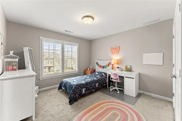 a bedroom with a bed and a dresser in it