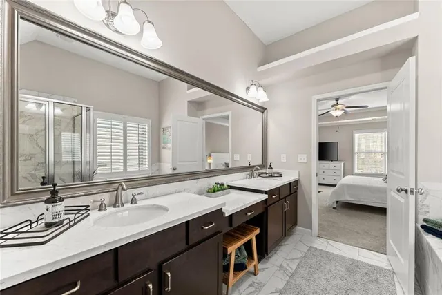 a spacious bathroom with a double vanity sink a and a mirror