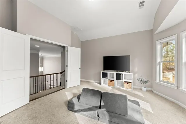 a bedroom with furniture and a large window