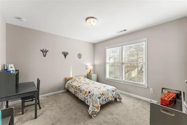 a bedroom with bed and a window