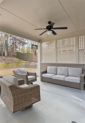 a living room with furniture and a floor to ceiling window