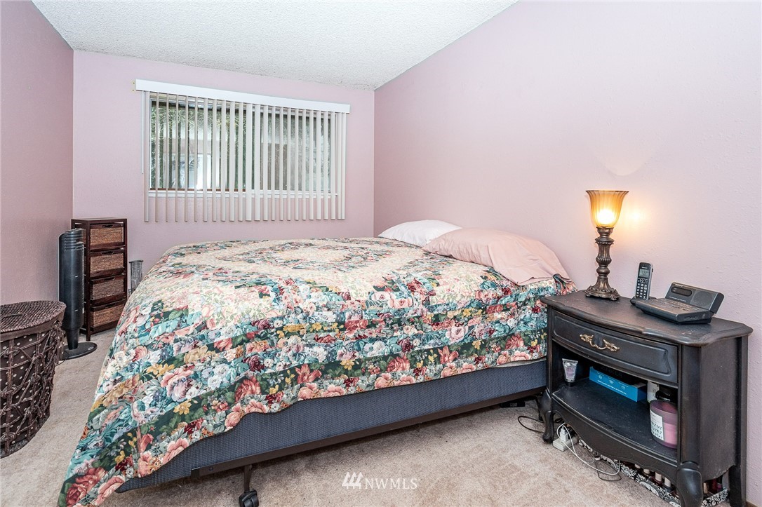 180 Winter Road Winlock, WA 98596 - Photo 11 of 40 a bed sitting in a bedroom next to a lamp