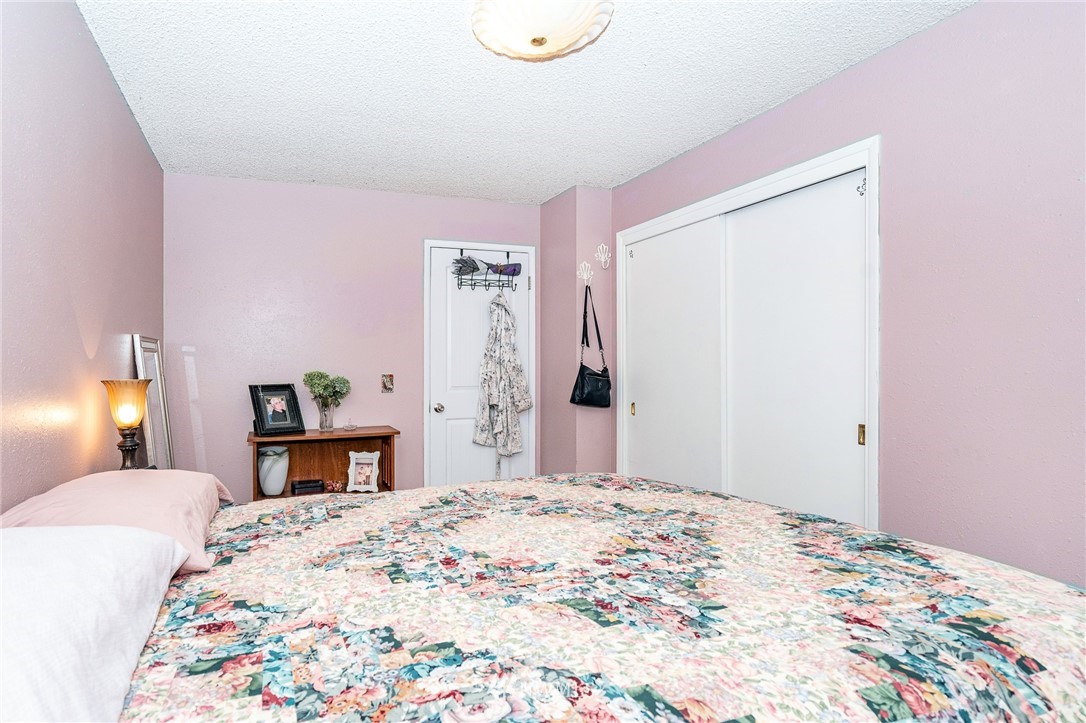 180 Winter Road Winlock, WA 98596 - Photo 39 of 40 a bedroom with a bed and a chandelier
