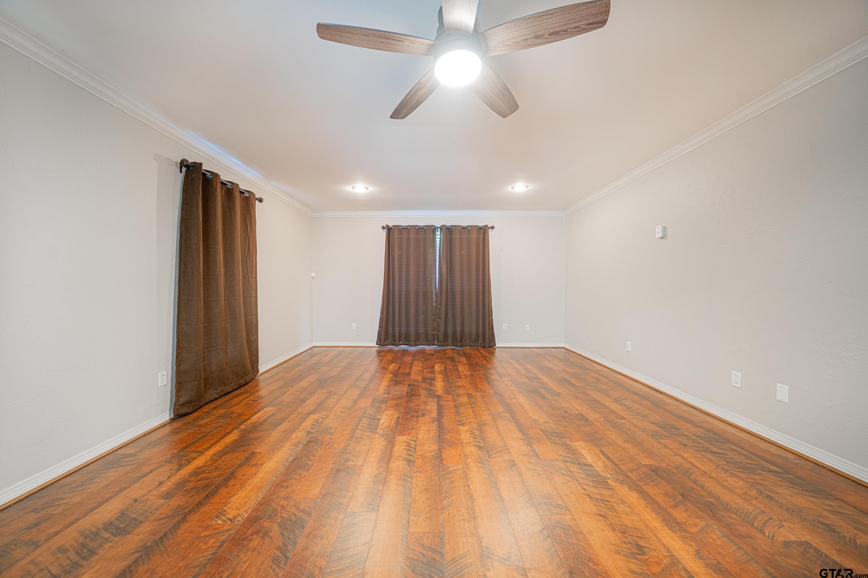 1704 West Northwood Court Longview, TX 75605 - Photo 18 of 32 a view of an empty room with a ceiling fan