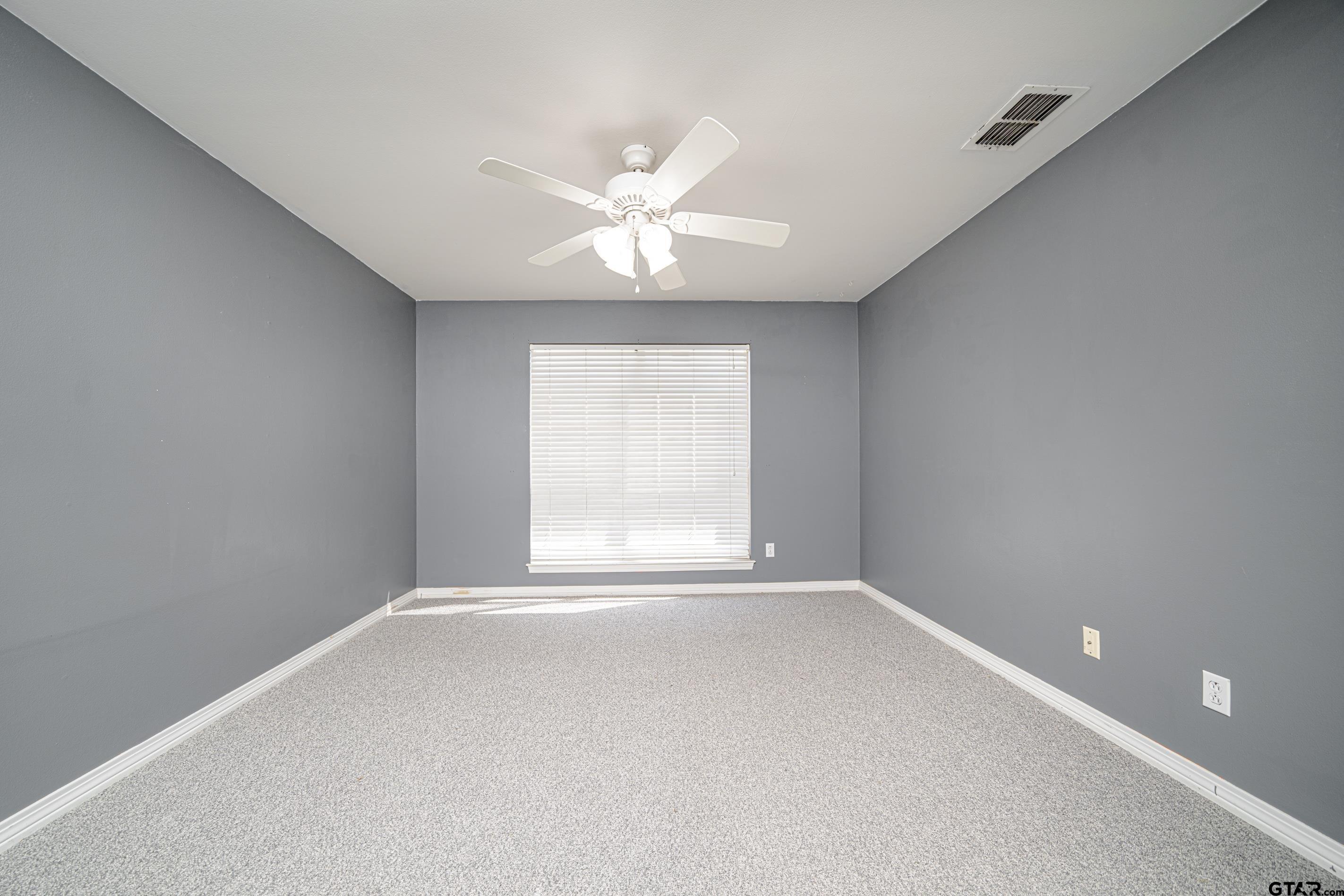1704 West Northwood Court Longview, TX 75605 - Photo 21 of 32 wooden floor in an empty room with a window