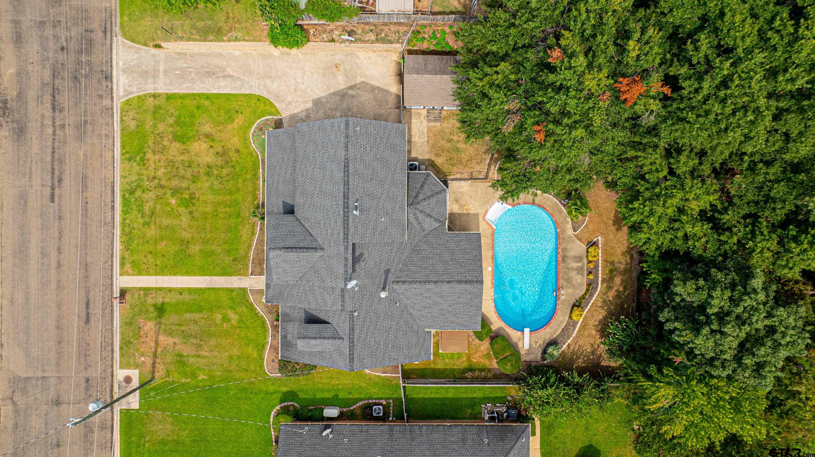 1704 West Northwood Court Longview, TX 75605 - Photo 31 of 32 an aerial view of a house with a swimming pool