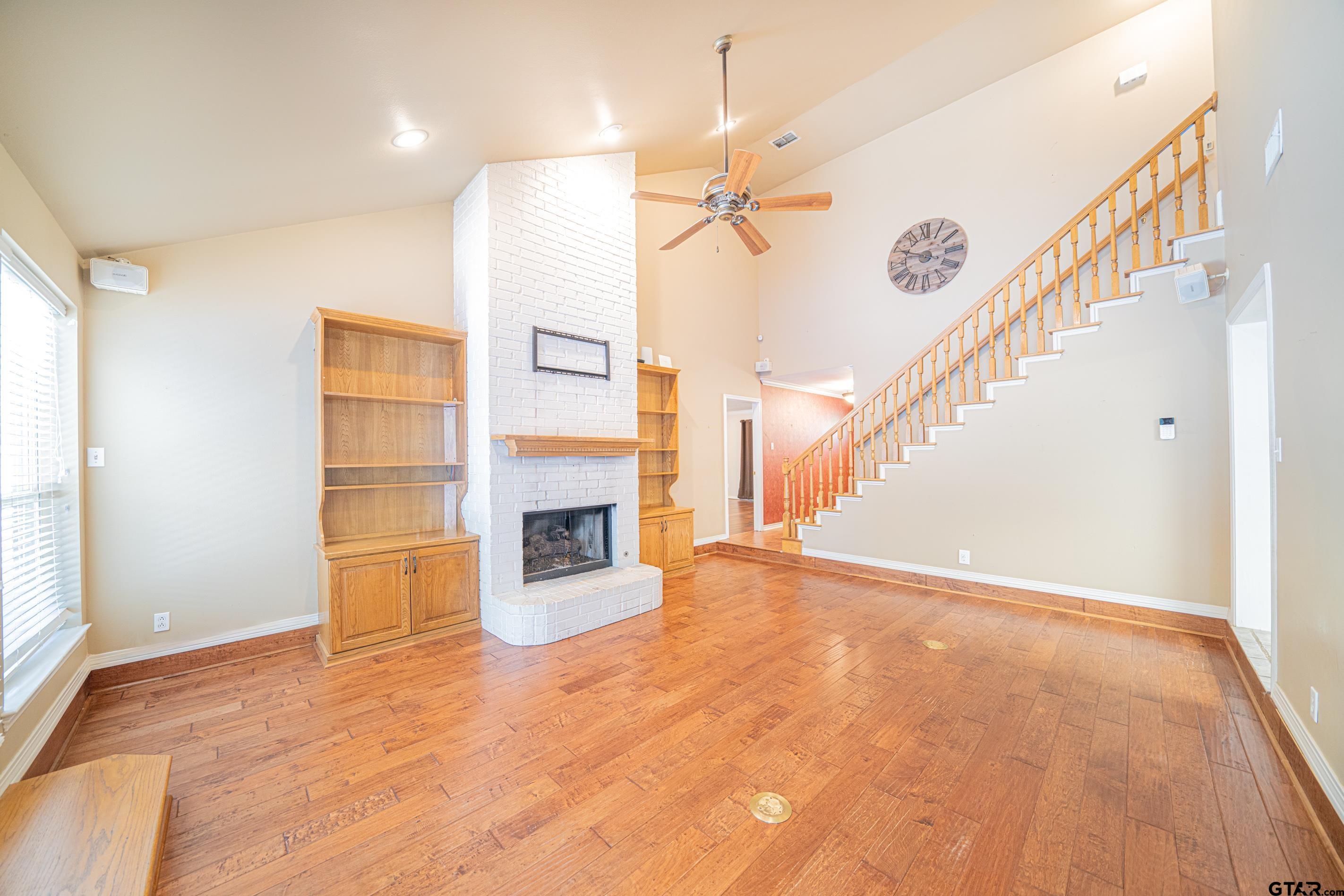 1704 West Northwood Court Longview, TX 75605 - Photo 4 of 32 a view of empty room with fireplace and wooden floor