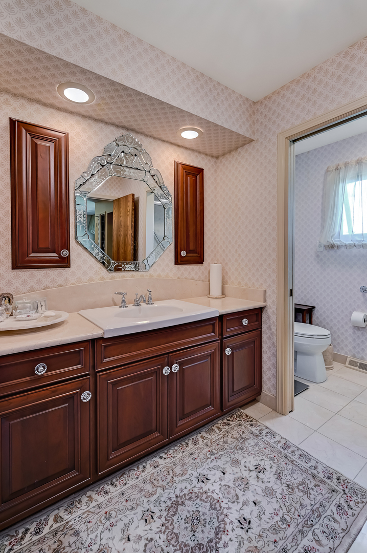 107 Stirrup Lane Burr Ridge, IL 60527 - Photo 21 of 37 a spacious bathroom with a granite countertop double vanity sink and a mirror