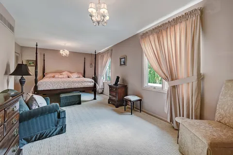 a bedroom with furniture and a window