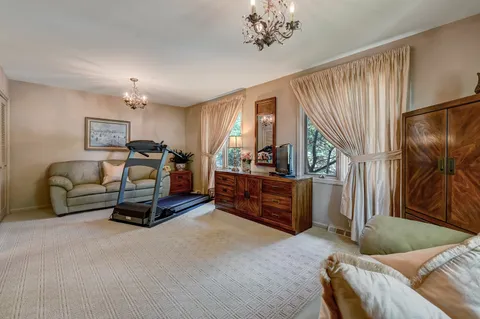 a bedroom with furniture and a window