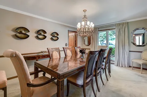 a view of a dining room with furniture and chandelier