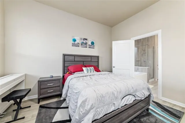 a bedroom with a bed and a desk