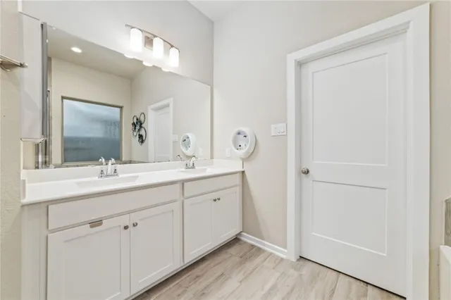 a white bath tub sitting next to a shower