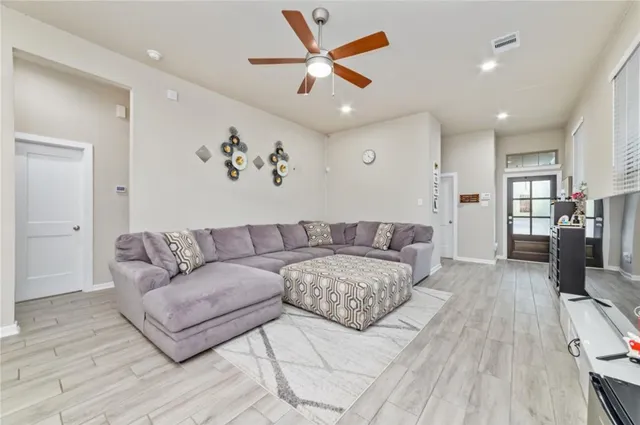 a living room with furniture and wooden floor