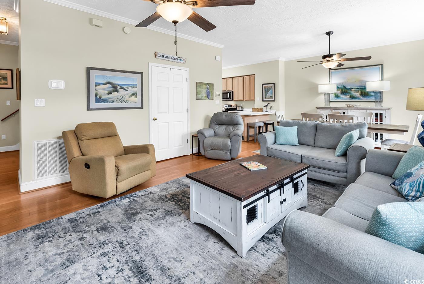 17 South Oak Drive Surfside Beach, SC 29575 - Photo 13 of 38 Living area featuring a ceiling fan, wood finished floors, ornamental molding, and baseboards