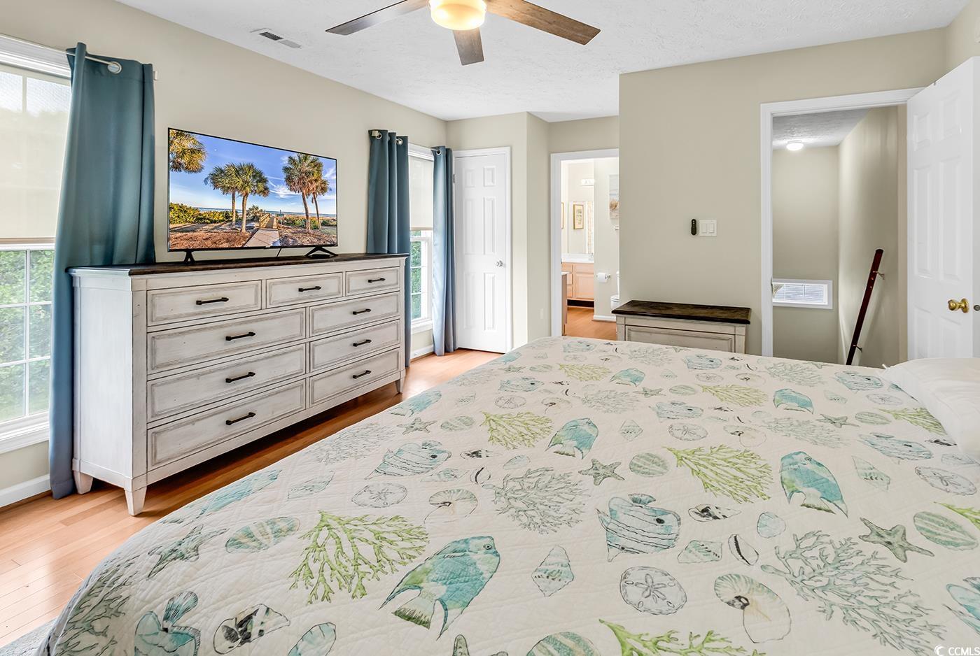 17 South Oak Drive Surfside Beach, SC 29575 - Photo 20 of 38 Bedroom with light wood-style floors, ensuite bath, and ceiling fan
