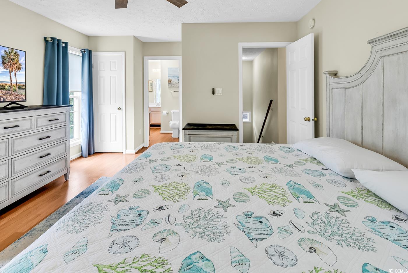 17 South Oak Drive Surfside Beach, SC 29575 - Photo 21 of 38 Bedroom featuring light wood-style floors, connected bathroom, and ceiling fan