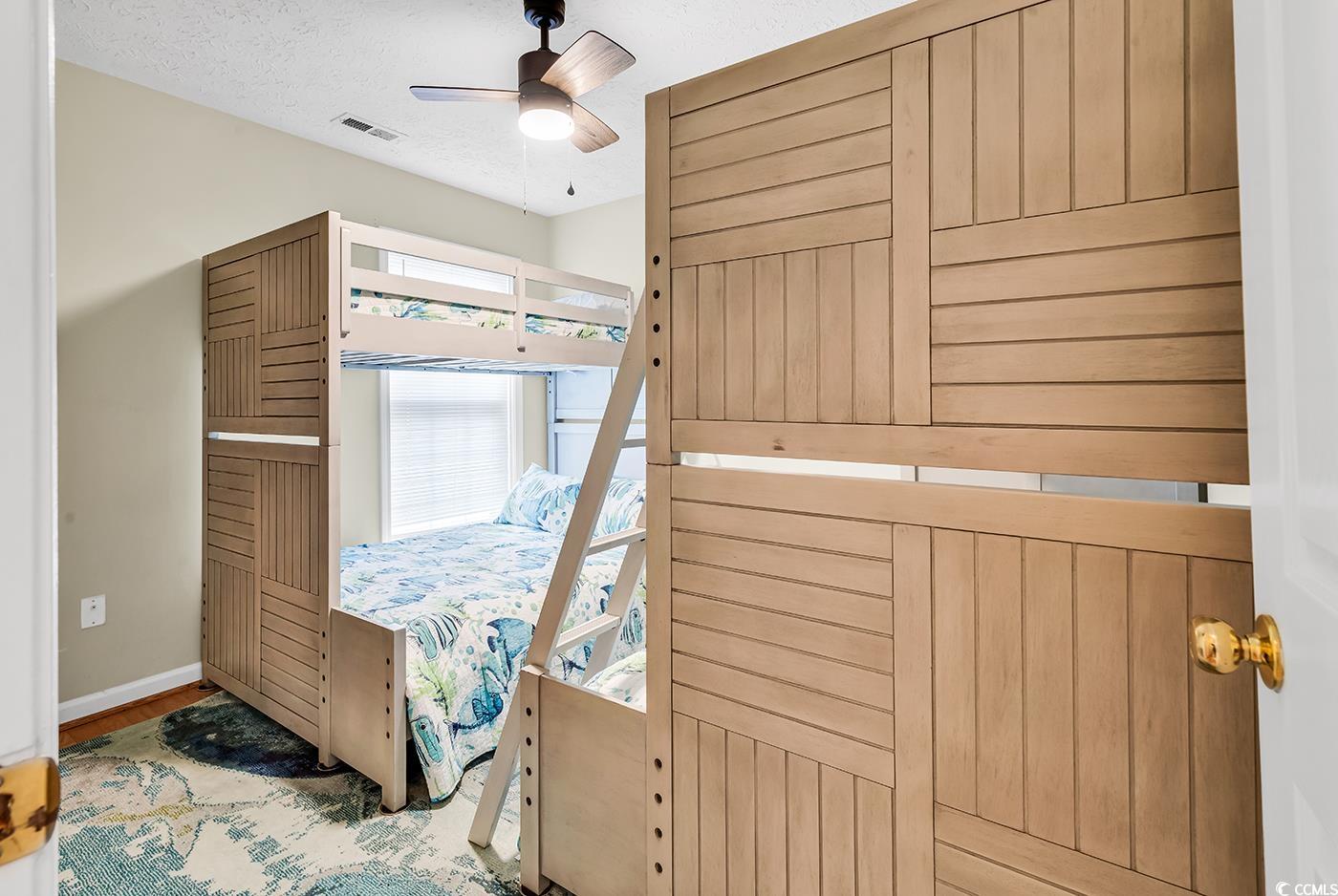 17 South Oak Drive Surfside Beach, SC 29575 - Photo 27 of 38 Bedroom featuring baseboards, wood finished floors, a textured ceiling, and ceiling fan