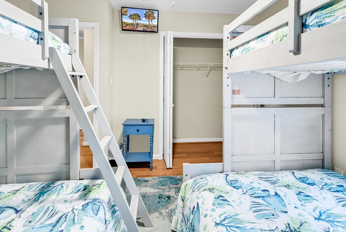 17 South Oak Drive Surfside Beach, SC 29575 - Photo 29 of 38 Bedroom featuring a closet, wood finished floors, and baseboards