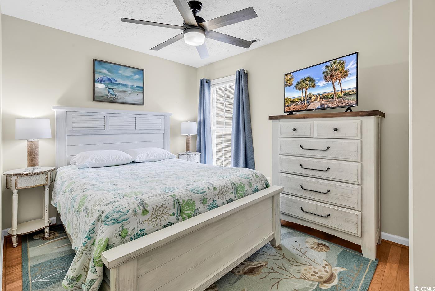 17 South Oak Drive Surfside Beach, SC 29575 - Photo 32 of 38 Bedroom with wood finished floors, a textured ceiling, baseboards, and ceiling fan